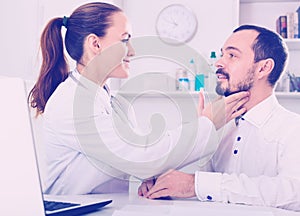 Man having consultation with female doctor in hospital