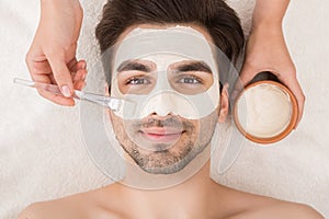 Man having cosmetic mask in spa salon