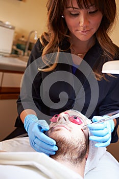 Man Having Dermo Abrasion Cosmetic Treatment At Spa photo