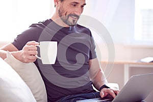 Man having drink and working on computer