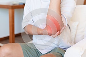 Man having elbow ache and muscle pain due to lateral epicondylitis or tennis elbow. injuries and medical concept