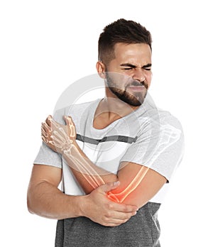 Man having elbow pain on white background. Digital compositing with illustration of arm bones photo