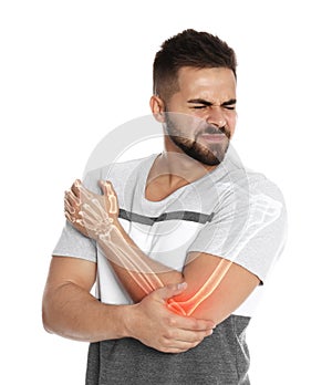 Man having elbow pain on white background. Digital compositing with illustration of arm bones