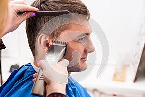 Man Having Hair Cut by Stylist in Salon