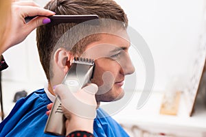 Man Having Hair Cut by Stylist in Salon photo