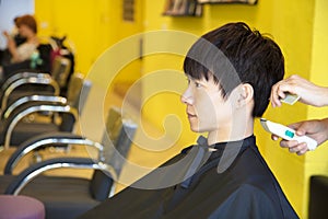 Man having haircut with hair clippers