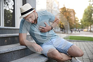 Man having heart attack on city street