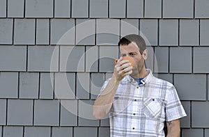 Man having a hot beverage outside.