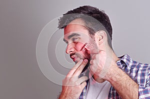 Man having irritation while shaving, photo manipulation