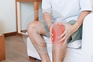 Man having knee ache and muscle pain due to Runners Knee or Patellofemoral Pain Syndrome, osteoarthritis, arthritis, rheumatism