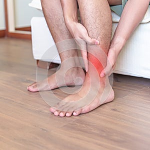 Man having leg pain due to Ankle Sprains or Achilles Tendonitis and Shin Splints ache. injuries, health and medical concept