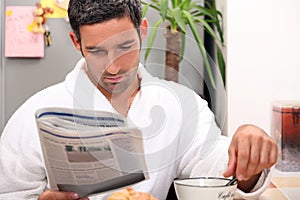 Man having a leisurely breakfast photo
