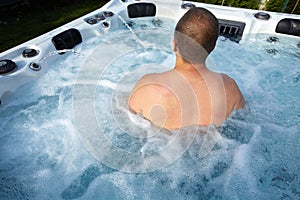 Man having massage in hot tub spa.