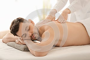 Man having massage in spa salon