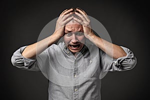 Man having panic attack on dark background