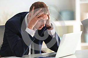 Man having panic attack at workplace in office