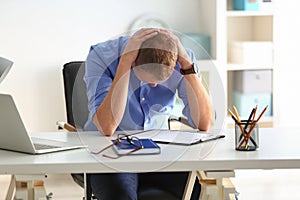 Man having panic attack at workplace in office