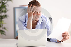 Man having panic attack at workplace in office