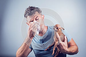 Man having pet allergy symptoms : runny nose, asthma