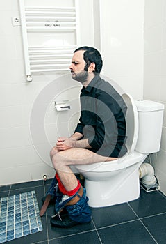 Man having problems in toilet