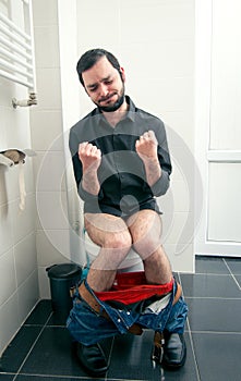 Man having problems in toilet