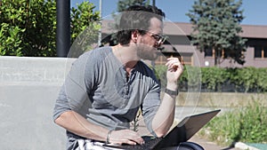 Man having problems working on his laptop outdoor. Stress concept