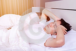 Man having sleepless on bed and having migraine,stress, insomnia