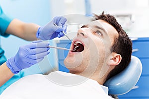 Man having teeth examined at dentists