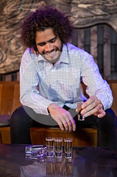 Man having a tequila in bar