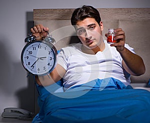 Man having trouble sleeping in bed