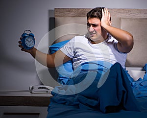 Man having trouble sleeping in bed