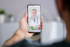 Man Having Video Chat With Doctor On Phone
