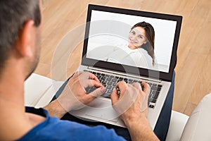 Man having a videochat with woman