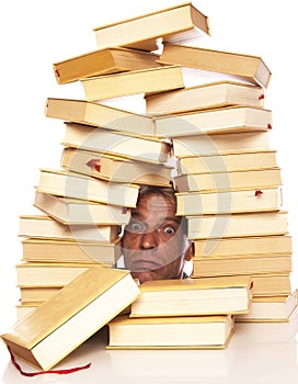Man with head between books on a white background