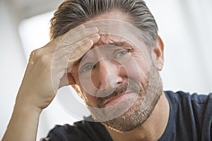 Man With Headache Rubbing Forehead photo