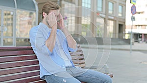 Man with Headache Sitting Outdoor on Bench
