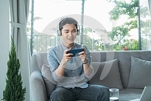 Man headphone mobile sofa game