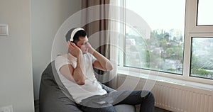 Man in headphones listening to music at home