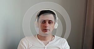 Man in headphones listening to music at home