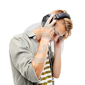 Man, headphones and listening to music for podcast, audio streaming or DJ against a white studio background. Male person
