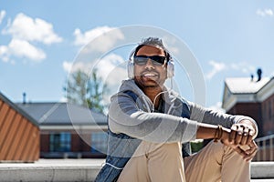 Man in headphones listening to music on roof top