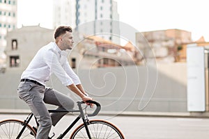 Man with headphones riding bicycle on city street