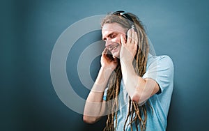 Man with headphones on a solid background