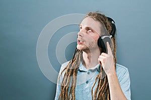 Man with headphones on a solid background