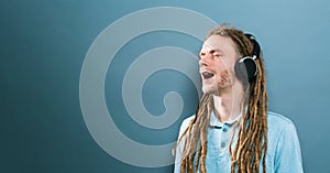 Man with headphones on a solid background