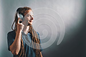 Man with headphones on a solid background