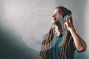 Man with headphones on a solid background