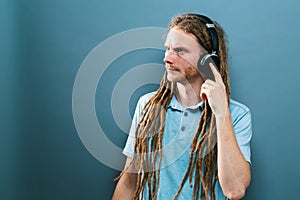 Man with headphones on a solid background