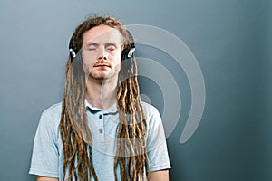 Man with headphones on a solid background