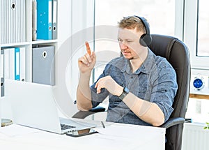 Man in headphones teleworking